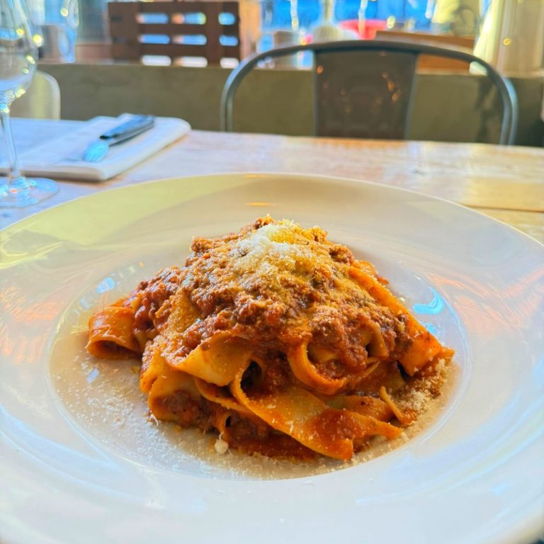 Slow-cooked ragù Bolognese made with beef and tomatoes, served over fresh tagliatelle pasta at Amore & Limoncello Italian restaurant